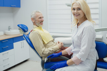 Obraz premium Dental doctor treating a male patient in hospital.