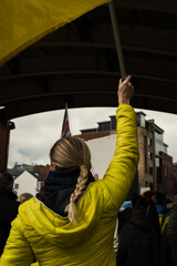 A girl holds a Ukrainian flag at a rally in Manchester