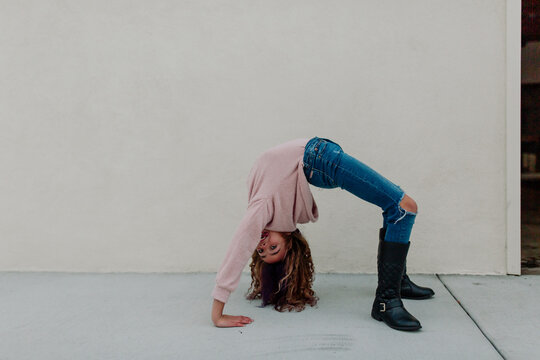 Tween girl does back handstand