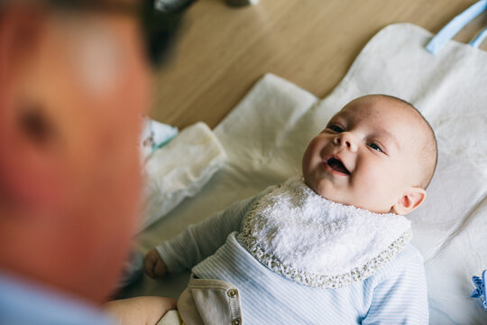 Grandfather changing diaper for newborn grandchild 