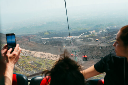 Tourists taking photos in Mount Etna funicular 