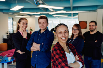 Portrait of a successful creative businessman and businesswoman looking at camera and smiling. Diverse business people standing together at startup.