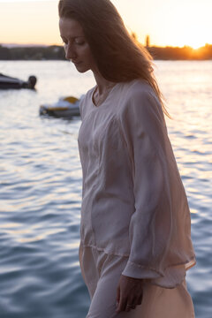 portrait of sad woman looking down near lake, mental health