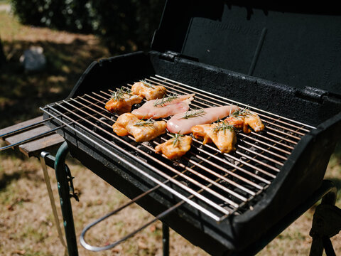 Cooking meat on grill outside