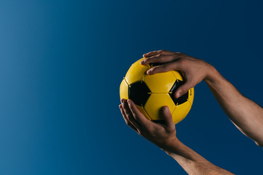 Man´s hands holding a soccer ball 