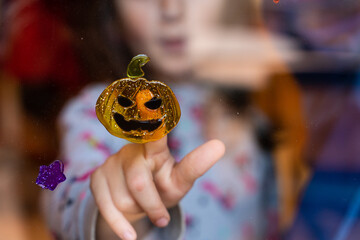 Children decorating for Halloween with jack-o'-lantern pumpkin