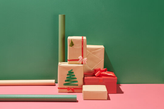 Christmas wrapped gift boxes on pink table background