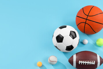 Many different sports balls on light blue background, flat lay. Space for text