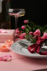 Foto op Canvas Place setting with roses and candles on pink wooden table, closeup. Romantic dinner © New Africa