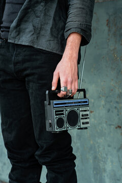Rock style hand holding retro radio