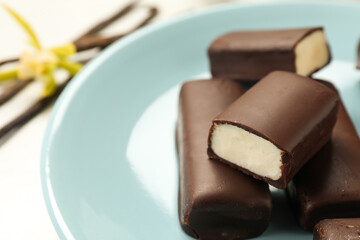 Glazed curd cheese bars on white table, closeup