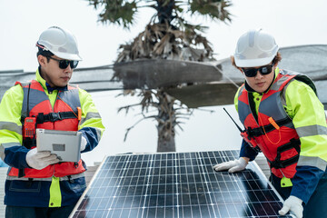 engineer men inspect modules of photovoltaic cell panels. Industrial Renewable energy of green power. workers prepare materials before construction on site with the stack of panels at background.