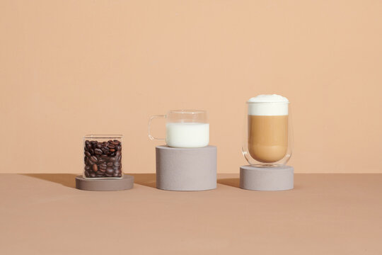 cappuccino in glass with double walls on brown table with coffee