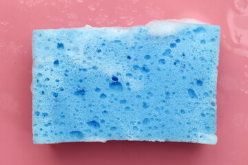 Cleaning sponge in foam of dishwashing liquid. Washing dishes concept