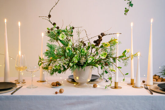 Festive Christmas table decoration arrangement with burning candles