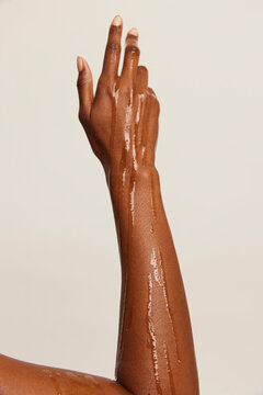 Oil dripping down woman's arm