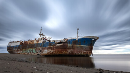 Abandoned Shipwreck on a Deserted Shoreline at Dusk