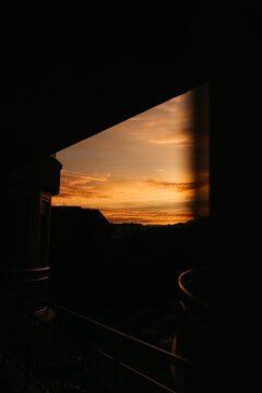 A sunrise seen through an apartment window and curtains