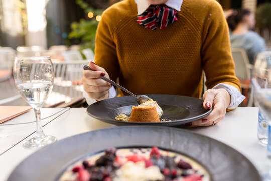 Woman eating her dessert in restaurant