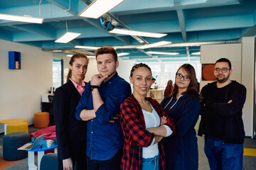 Portrait of a successful creative businessman and businesswoman looking at camera and smiling. Diverse business people standing together at startup.