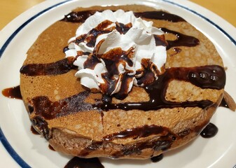 Chocolate chip cookie dough pancake with white cream and syrup