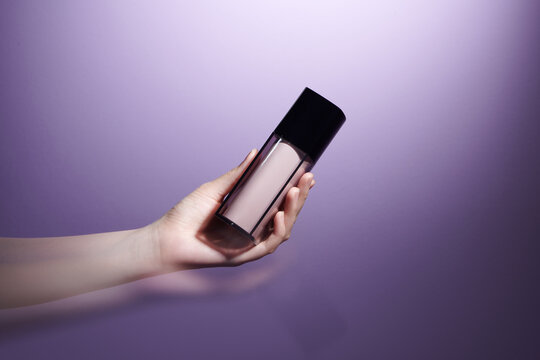 Hand holding makeup liquid found