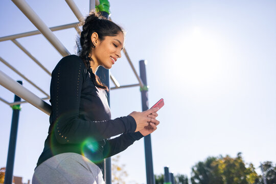 smiling fit sportswoman having break during workout