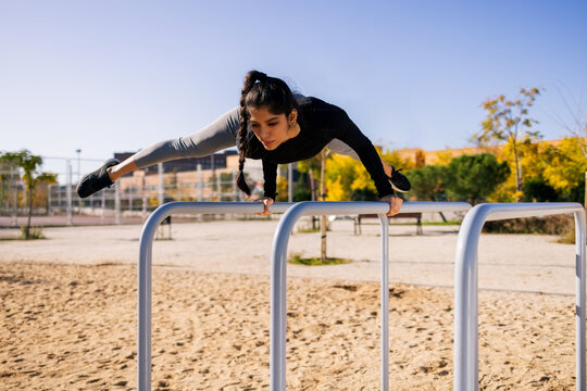 Athlete doing handstand on parallel bars during calisthenics workout