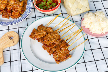 Grilled skewered milk pork with white sticky rice - local Thai street food style