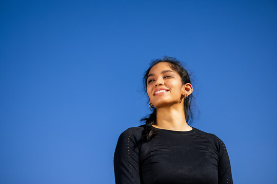 Fit happy sportsWoman smiling and confidently looking away