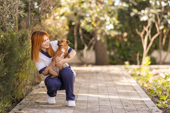 Caregiver caressing a therapy dog in the residence