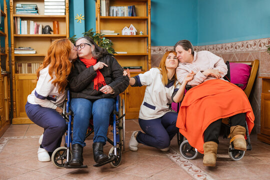 Two caregivers with patients at the disability care facility
