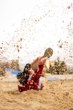 Paralympic athlete with a leg prosthesis in a long jump training 