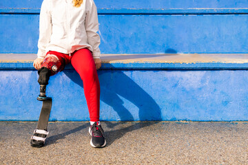 Lower body of paralympic woman athlete with bionic leg prosthesis 