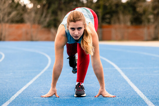 Paralympic athlete with a bionic leg prosthesis ready for a sprint