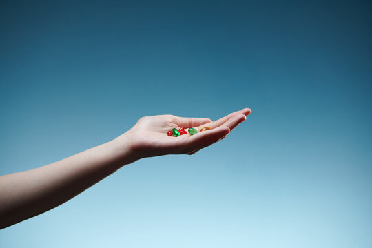 mix of many gel capsule of vitamin eating in female hand palm