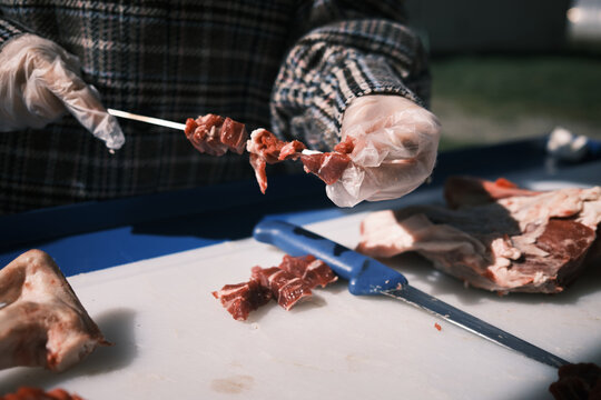 Closeup Of A Butcher Processing Raw Lamb Meat On A Farm