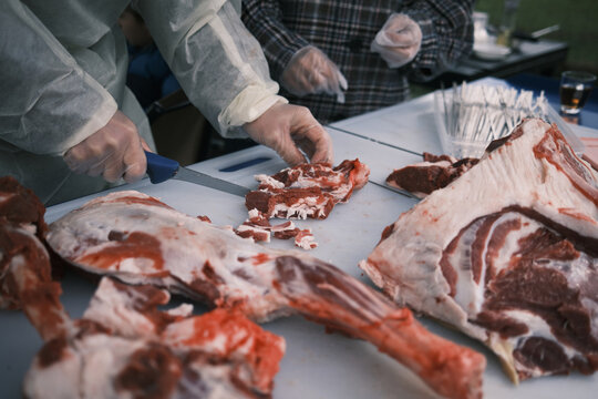 Closeup Of A Butcher Processing Raw Lamb Meat On A Farm