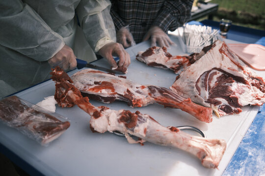Closeup Of A Butcher Processing Raw Lamb Meat On A Farm
