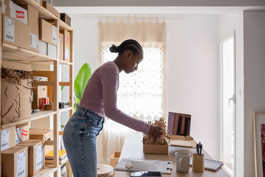 Female employee putting shredded paper in container