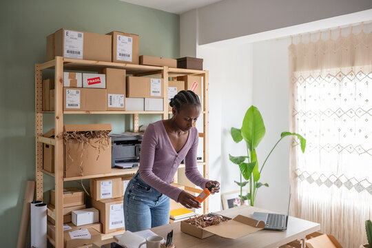 Female employee packing beauty products in box