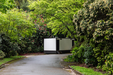Portable Mobile Public Toilet Restroom Along Forest Pathway