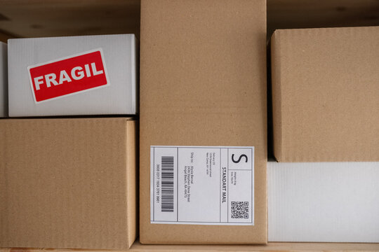 Cardboard boxes with labels in delivery office