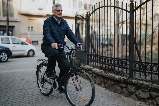 Active elderly gentleman cycling on a city street with a smile, embracing a healthy lifestyle and urban mobility. The image conveys vitality and independence in older age.