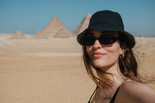 Tourist woman selfie at egypt pyramids