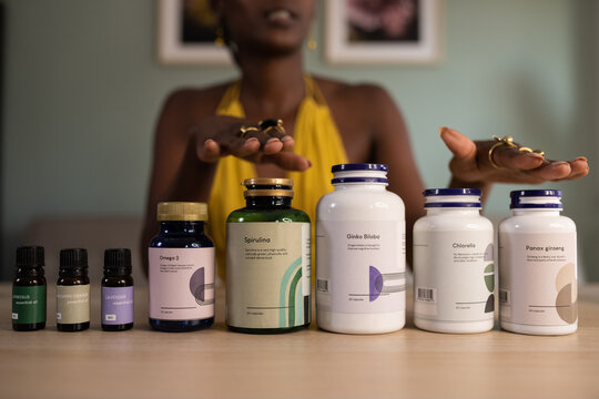 Crop black female talking about dietary supplements