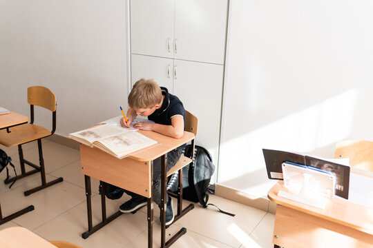 student at desk in light classroom