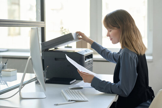 Office Worker Checking Copy Of Document