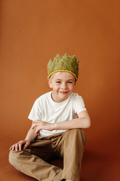 Boy sitting down in studio for birthday portrait