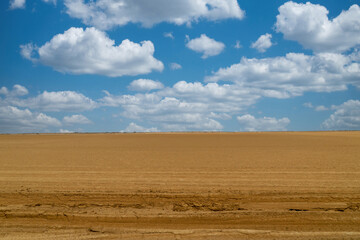 Fototapeta na wymiar Arid landscape in Punta Gallinas desert and blue sky. Guajira, Colombia.